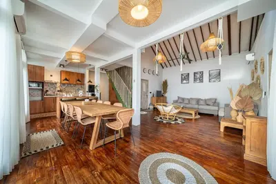 a living room with a table and a couch at Villa Arisanti in Kerobokan