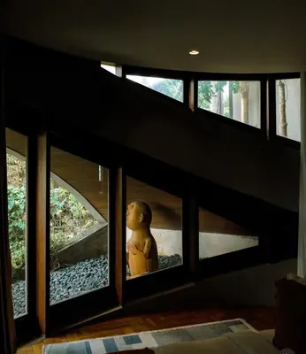 a teddy bear sitting in the window of a house at Dacolina House Jimbaran in Jimbaran