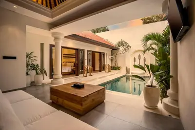 a villa with a swimming pool and a living room at Priviere Seminyak - 2BR Villa with Pool Near Beach in Seminyak