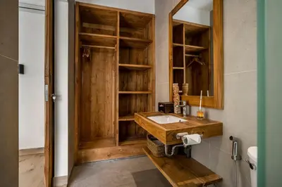 a bathroom with a wooden sink and a mirror at Priviere Seminyak - 2BR Villa with Pool Near Beach in Seminyak
