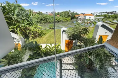 a view from the balcony of a house with a swimming pool at Luxury Couple 2 BR Villa Umalas, Rooftop, Pool & View in Kerobokan