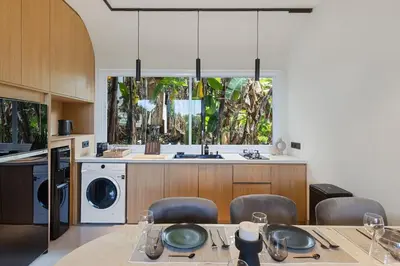 a kitchen with a table with chairs and a sink at Luxury Couple 2 BR Villa Umalas, Rooftop, Pool & View in Kerobokan