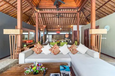 a living room with a couch and a table at Joglo-Style 3 Bedroom Villa in Heart Of Seminyak in Seminyak