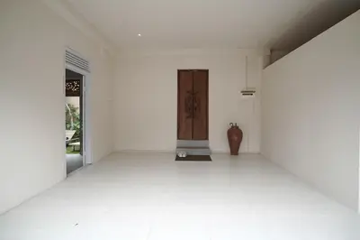 an empty room with a door and a vase at Cleo Villa Padma Legian in Seminyak