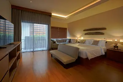 a large bedroom with a bed and a couch at Cleo Villa Padma Legian in Seminyak