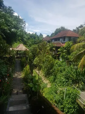a view of a garden with trees and buildings at 24/7 Bed & Breakfast in Jimbaran