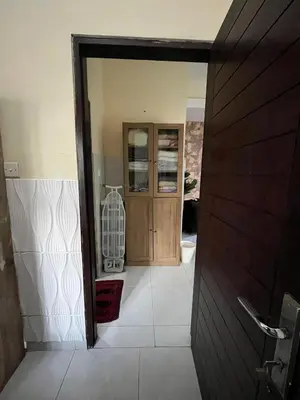 a hallway leading to a bathroom with a wooden door at 2 Bedroom Guest House Near Jimbaran Beach in Jimbaran