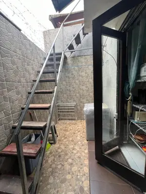 a metal staircase in a room with a mirror at 2 Bedroom Guest House Near Jimbaran Beach in Jimbaran