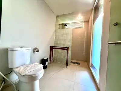 a bathroom with a toilet and a shower at Dealton Hotel Sanur in Sanur