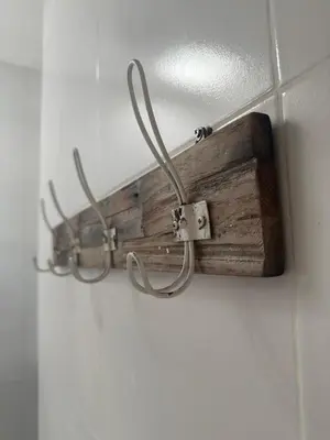 a wooden object is hanging on a wall at Gypsy Boutique Villa in Seminyak