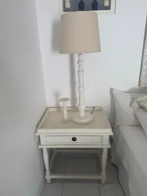a white table with a lamp on it next to a bed at Gypsy Boutique Villa in Seminyak
