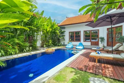 a swimming pool in the backyard of a villa at Villa WENDY Mertanadi in Seminyak