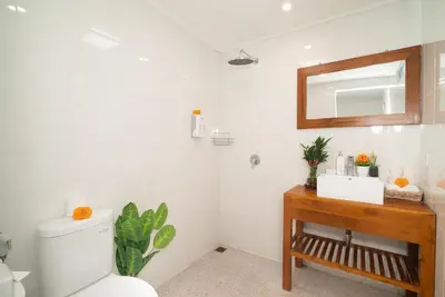 a bathroom with a toilet and a sink and a mirror at Villa WENDY Mertanadi in Seminyak