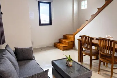 a living room with a couch and a table at Glory Rentals in Kuta