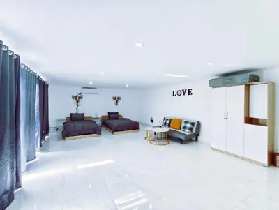 a living room with two beds and a couch at Joy Private Pool Villa in Kuta