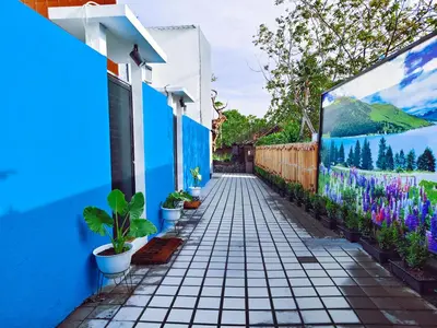 a street with blue walls and potted plants at Joy Private Pool Villa in Kuta