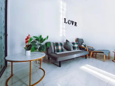 a living room with a couch and a table at Joy Private Pool Villa in Kuta
