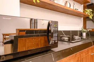 a microwave oven sitting on top of a kitchen counter at Green Mutiara Jimbaran in Jimbaran