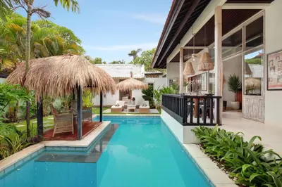 an exterior view of a villa with a swimming pool at Seminyak Beach Seagrass Villa 4BR - pool & staff in Seminyak