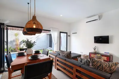 a living room with a table and a couch at Villa Suka Saki Seminyak with pool, wifi, & staff in Seminyak