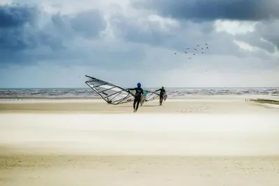 two people flying a kite on the beach at Villa Sobramesa Seminyak with pool, butler & parking in Seminyak