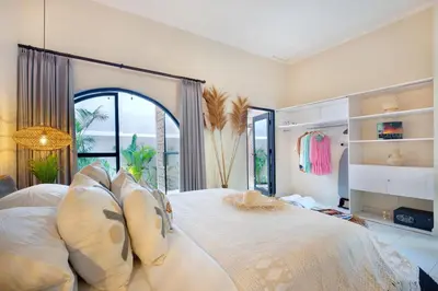 a large bedroom with a large bed with pillows at Villa Sobramesa Seminyak with pool, butler & parking in Seminyak
