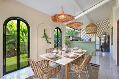 a kitchen and dining room with a table and chairs at Villa Sobramesa Seminyak with pool, butler & parking in Seminyak
