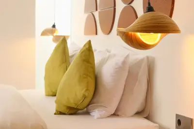 a group of pillows on a couch with a lamp at Rowena Comfortable 2 BR Private Pool Villa in Canggu