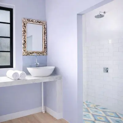 a white bathroom with a sink and a mirror at 3BR Canggu Batu Belig Tropicana Villa - Walk to Beach in Canggu