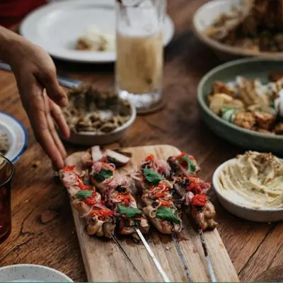 a table with a cutting board with food on it at 3BR Canggu Batu Belig Tropicana Villa - Walk to Beach in Canggu