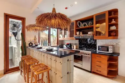 a kitchen with a large island with a counter top at 5BR Luxury Berawa Canggu with Butler in Canggu