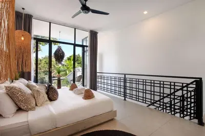 a bedroom with a bed and a large window at 1BR Villa Private Pool Seminyak Mertanadi in Seminyak