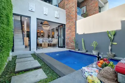a swimming pool in the backyard of a house at 1BR Villa Private Pool Seminyak Mertanadi in Seminyak