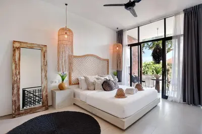 a bedroom with a white bed and a mirror at 1BR Villa Private Pool Seminyak Mertanadi in Seminyak