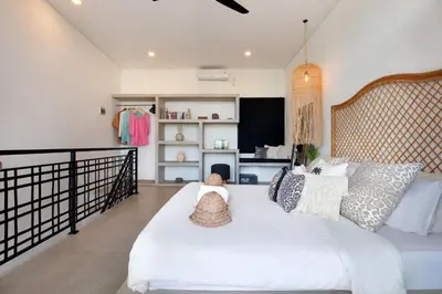 a bedroom with a large white bed with pillows at 1BR Villa Private Pool Seminyak Mertanadi in Seminyak