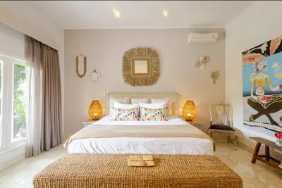a bedroom with a large white bed with two lamps at 6BR Luxe Pool Villa Seminyak Group Escape in Seminyak