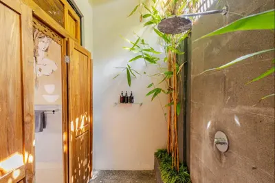 a bathroom with a plant on the wall at 6BR Luxe Pool Villa Seminyak Group Escape in Seminyak
