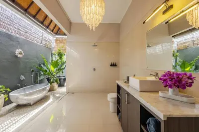 a bathroom with a tub and a sink and a mirror at 6BR Luxe Pool Villa Seminyak Group Escape in Seminyak