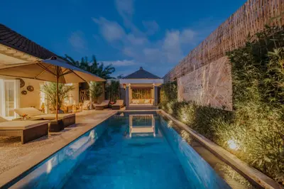 a swimming pool in front of a house at 6BR Luxe Pool Villa Seminyak Group Escape in Seminyak