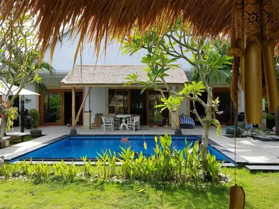 a swimming pool in front of a house at Elegant oasis between Canggu and Seminyak in Kerobokan