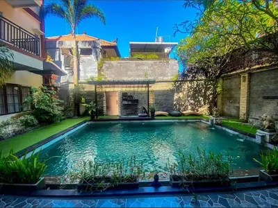 a swimming pool in the yard of a house at DBI Hotel - 1 minute to the Beach and 1 second to the Mall in Ngurah Rai International Airport