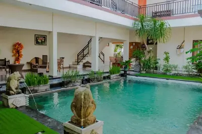 a swimming pool in the middle of a house at DBI Hotel - 1 minute to the Beach and 1 second to the Mall in Ngurah Rai International Airport