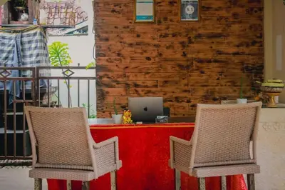 two chairs sitting in front of a table with a laptop at DBI Hotel - 1 minute to the Beach and 1 second to the Mall in Ngurah Rai International Airport