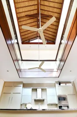 a ceiling fan in the kitchen of a house at Villa Tentrem Legian in Legian