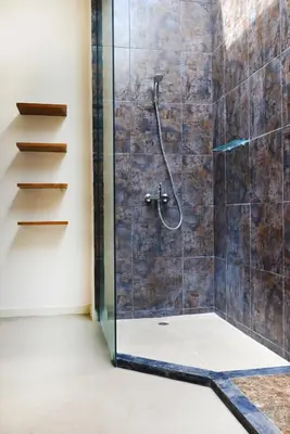 a bathroom with a shower with a glass door at Villa Tentrem Legian in Legian