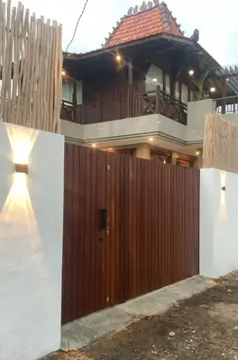 a house with a wooden fence and a wooden gate at 1BR Japanese Inspired Bali Villa in Kerobokan in Kerobokan