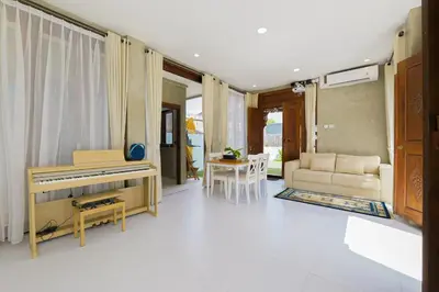 a living room with a piano and a table at 1BR Japanese Inspired Bali Villa in Kerobokan in Kerobokan