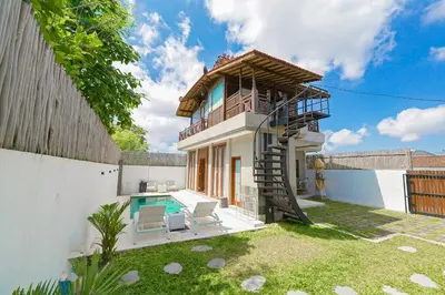 a house with a spiral staircase and a pool at 1BR Japanese Inspired Bali Villa in Kerobokan in Kerobokan
