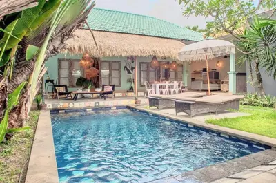 a swimming pool in front of a house at 2 BR Central Seminyak Villa Hibiscus Walk to shop and Beach in Seminyak