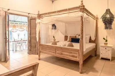 a bedroom with a canopy bed in a room at 2 BR Central Seminyak Villa Hibiscus Walk to shop and Beach in Seminyak